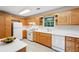 Classic kitchen featuring white appliances, countertops, and light wood cabinetry at 2624 Lake Erin Drive Dr, Tucker, GA 30084
