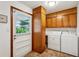 Functional laundry room with washer, dryer, cabinets and utility sink, perfect for chores at 2624 Lake Erin Drive Dr, Tucker, GA 30084