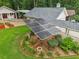 Solar panels in a landscaped yard with flower beds and greenery, providing sustainable energy at 2624 Lake Erin Drive Dr, Tucker, GA 30084