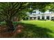 Beautiful backyard featuring a sprawling lawn, mature trees, and tranquil seating area at 2795 Peachtree Ne Rd # 1009, Atlanta, GA 30305