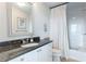 Well-lit bathroom featuring a vanity with granite countertop, decorative mirror, and a shower with curtain at 2795 Peachtree Ne Rd # 1009, Atlanta, GA 30305