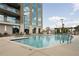 Resort-style swimming pool surrounded by lounge chairs, lush landscaping, and building views at 2795 Peachtree Ne Rd # 1009, Atlanta, GA 30305