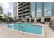 Resort-style swimming pool surrounded by lounge chairs, lush landscaping, and building views at 2795 Peachtree Ne Rd # 1009, Atlanta, GA 30305