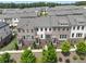 An aerial view of townhomes featuring brick facades, covered entries, balconies, and manicured landscaping at 416 Montclair Ct, Woodstock, GA 30188