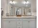 Bathroom featuring a double-sink vanity, granite counters, and large mirror at 416 Montclair Ct, Woodstock, GA 30188