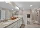 Bright bathroom with double sinks, granite counters, framed mirrors, and shower at 416 Montclair Ct, Woodstock, GA 30188