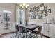 A dining room with a modern chandelier, gallery wall, and outdoor access at 416 Montclair Ct, Woodstock, GA 30188
