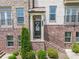 Charming brick townhome featuring a covered entry with address number 436 and landscaped front yard at 416 Montclair Ct, Woodstock, GA 30188