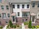 Beautiful brick townhome featuring a covered entry, balcony, and manicured landscaping at 416 Montclair Ct, Woodstock, GA 30188