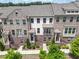 Charming townhome featuring a brick facade, covered entry, balcony, and professionally landscaped front yard at 416 Montclair Ct, Woodstock, GA 30188