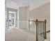 Upstairs hallway with carpet and wood-and-iron banister at 416 Montclair Ct, Woodstock, GA 30188