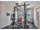 Fully equipped home gym with weightlifting equipment and ample workout space at 416 Montclair Ct, Woodstock, GA 30188