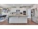 A bright kitchen featuring white cabinets, stainless steel appliances, and a center island at 416 Montclair Ct, Woodstock, GA 30188