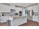 A modern kitchen featuring white cabinets, stainless steel appliances and granite counters at 416 Montclair Ct, Woodstock, GA 30188