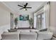 A cozy living room with a ceiling fan, television and bright natural light at 416 Montclair Ct, Woodstock, GA 30188