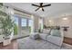 Bright and airy living room featuring french doors, a ceiling fan, hardwood floors, and a comfortable couch at 416 Montclair Ct, Woodstock, GA 30188