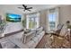 Comfortable living room with lots of natural light from french doors with white curtains and hardwood flooring at 416 Montclair Ct, Woodstock, GA 30188