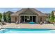 Community pool and pool house with outdoor seating and clear blue water at 416 Montclair Ct, Woodstock, GA 30188