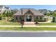 View of a brick pool house with manicured lawn and gated entrance to a community pool at 416 Montclair Ct, Woodstock, GA 30188