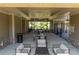 Covered seating area in a pool house with tables, chairs, and sofas overlooking the pool area at 416 Montclair Ct, Woodstock, GA 30188