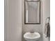 Elegant powder room with a pedestal sink, decorative mirror, and fresh paint at 416 Montclair Ct, Woodstock, GA 30188