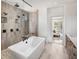 Luxury bathroom showcasing a soaking tub, walk-in shower, and modern fixtures at 6930 Pond View Dr, Cumming, GA 30028