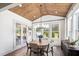 Charming dining room with wood paneled ceiling, a round table, and large windows showcasing scenic views at 6930 Pond View Dr, Cumming, GA 30028