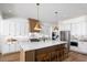 Beautiful kitchen featuring custom cabinetry, a large center island, and pendant lighting for a modern style at 6930 Pond View Dr, Cumming, GA 30028