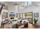 Inviting living room with a cozy fireplace, soaring ceilings, and large windows that offer great views at 6930 Pond View Dr, Cumming, GA 30028