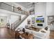 Elegant living room featuring high ceilings, a fireplace, a staircase, and comfortable seating areas at 6930 Pond View Dr, Cumming, GA 30028