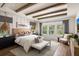 Serene main bedroom with wood beam ceilings, pendant lights, and large windows that allow in ample natural light at 6930 Pond View Dr, Cumming, GA 30028