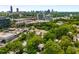 Aerial view of neighborhood with lush trees and city skyline at 819 Belgrade Ne Ave, Atlanta, GA 30306