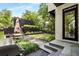 Landscaped backyard featuring a dining area, garden, and black painted building in the background at 819 Belgrade Ne Ave, Atlanta, GA 30306