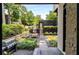 Modern backyard features an outdoor kitchen, dining area, and lush landscaping at 819 Belgrade Ne Ave, Atlanta, GA 30306
