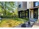 Spacious backyard with healthy lawn, stone pavers, lush greenery, and modern exterior at 819 Belgrade Ne Ave, Atlanta, GA 30306