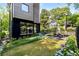 Landscaped backyard with dining area and modern home exterior at 819 Belgrade Ne Ave, Atlanta, GA 30306