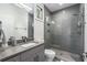 Modern bathroom featuring gray tiles, a glass-enclosed shower, and sleek fixtures at 819 Belgrade Ne Ave, Atlanta, GA 30306
