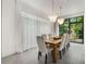 Bright dining room showcasing a wooden table, modern chandeliers, and floor to ceiling window at 819 Belgrade Ne Ave, Atlanta, GA 30306