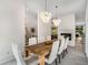 Elegant dining room featuring a large wooden table, stylish lighting, and bright white walls at 819 Belgrade Ne Ave, Atlanta, GA 30306