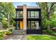 Modern two-story home featuring large windows, stone accents, and manicured landscaping at 819 Belgrade Ne Ave, Atlanta, GA 30306