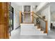 Bright foyer featuring a staircase with wooden handrail and tiled floor leading to the upper level at 819 Belgrade Ne Ave, Atlanta, GA 30306