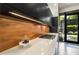 Sleek kitchen with white countertops, black cabinets, light backsplash and stainless gas cooktop at 819 Belgrade Ne Ave, Atlanta, GA 30306