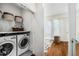 Well-organized laundry room with modern washer and dryer, shelving, and convenient storage solutions at 819 Belgrade Ne Ave, Atlanta, GA 30306