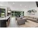 Open concept living area showcasing a kitchen with an island, modern seating, and expansive windows at 819 Belgrade Ne Ave, Atlanta, GA 30306