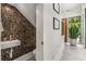 Stylish powder room featuring a unique tile wall and modern sink, creating a chic and functional space at 819 Belgrade Ne Ave, Atlanta, GA 30306