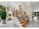 Elegant staircase with wood and metal railings, complemented by large windows offering natural light at 819 Belgrade Ne Ave, Atlanta, GA 30306