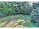 Sprawling backyard with mature trees and partial fencing at 1400 Scenic Brook Sw Trl, Conyers, GA 30094