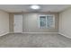 Finished basement featuring neutral carpeting, ample natural light from window and access to the exterior at 1400 Scenic Brook Sw Trl, Conyers, GA 30094