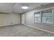 Finished basement featuring neutral carpeting, ample natural light from window and access to the exterior at 1400 Scenic Brook Sw Trl, Conyers, GA 30094