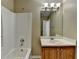 Bathroom featuring bathtub, mirror and vanity with sink and ample lighting at 1400 Scenic Brook Sw Trl, Conyers, GA 30094